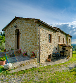 Three quarter view of the cottage with a wood-burning oven on its left side