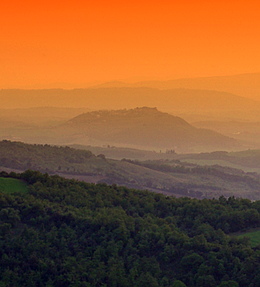 The farmland in the orange light of the sunset